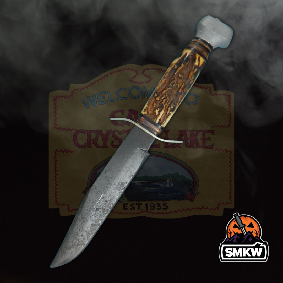 A decorative knife with a wooden handle against a smoky background.