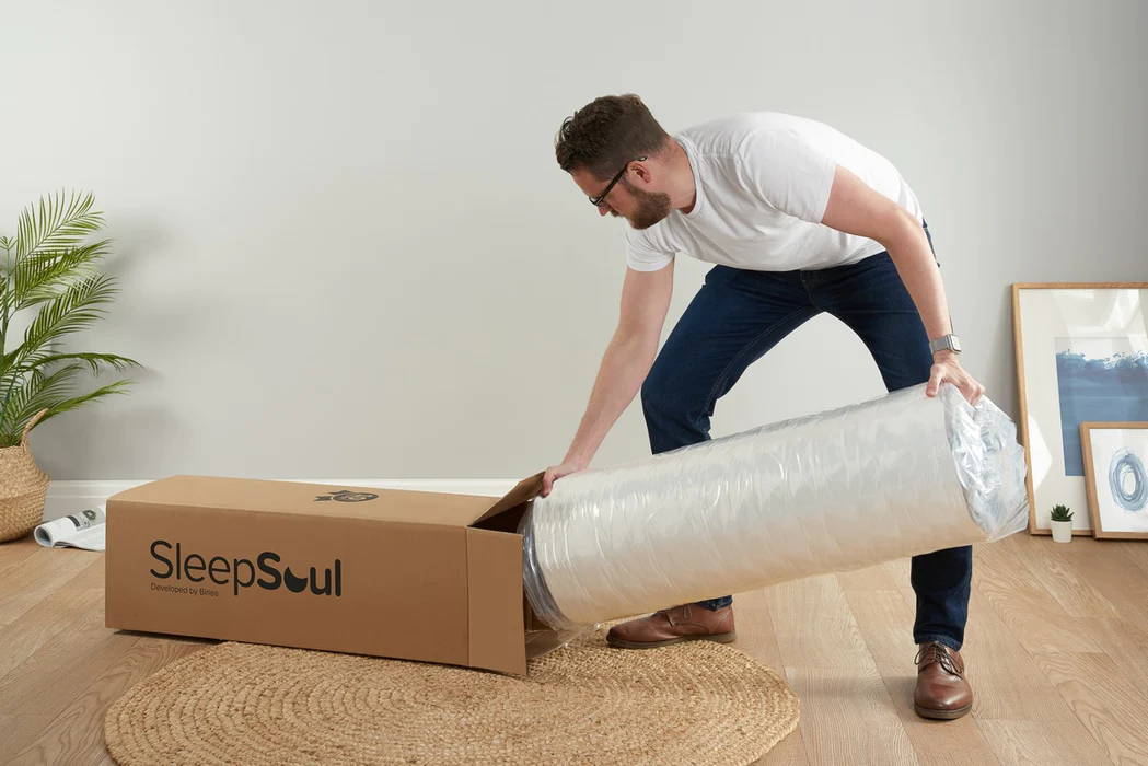 man unboxing a sleepsoul mattress