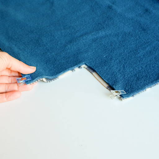 Mark and cut a 5 inch square in each corner of the tie blanket