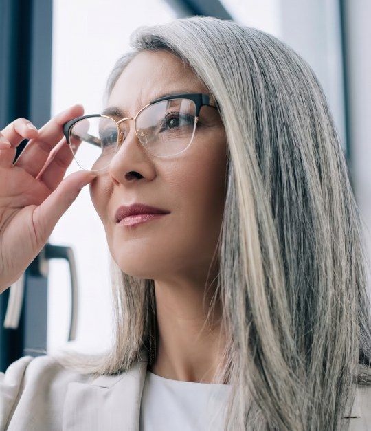 Woman with grey hair wearing Enchanted Gold cat eye glasses