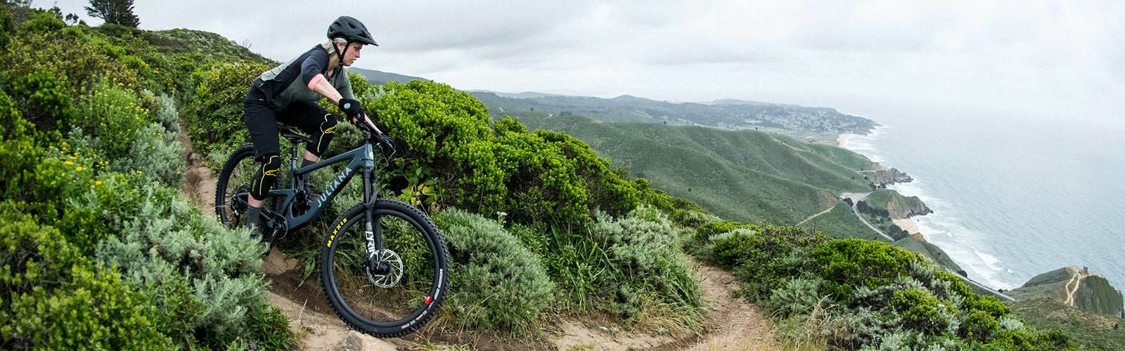 Downhill riding over the ocean on Juliana Bikes, the best women's mountain bikes.