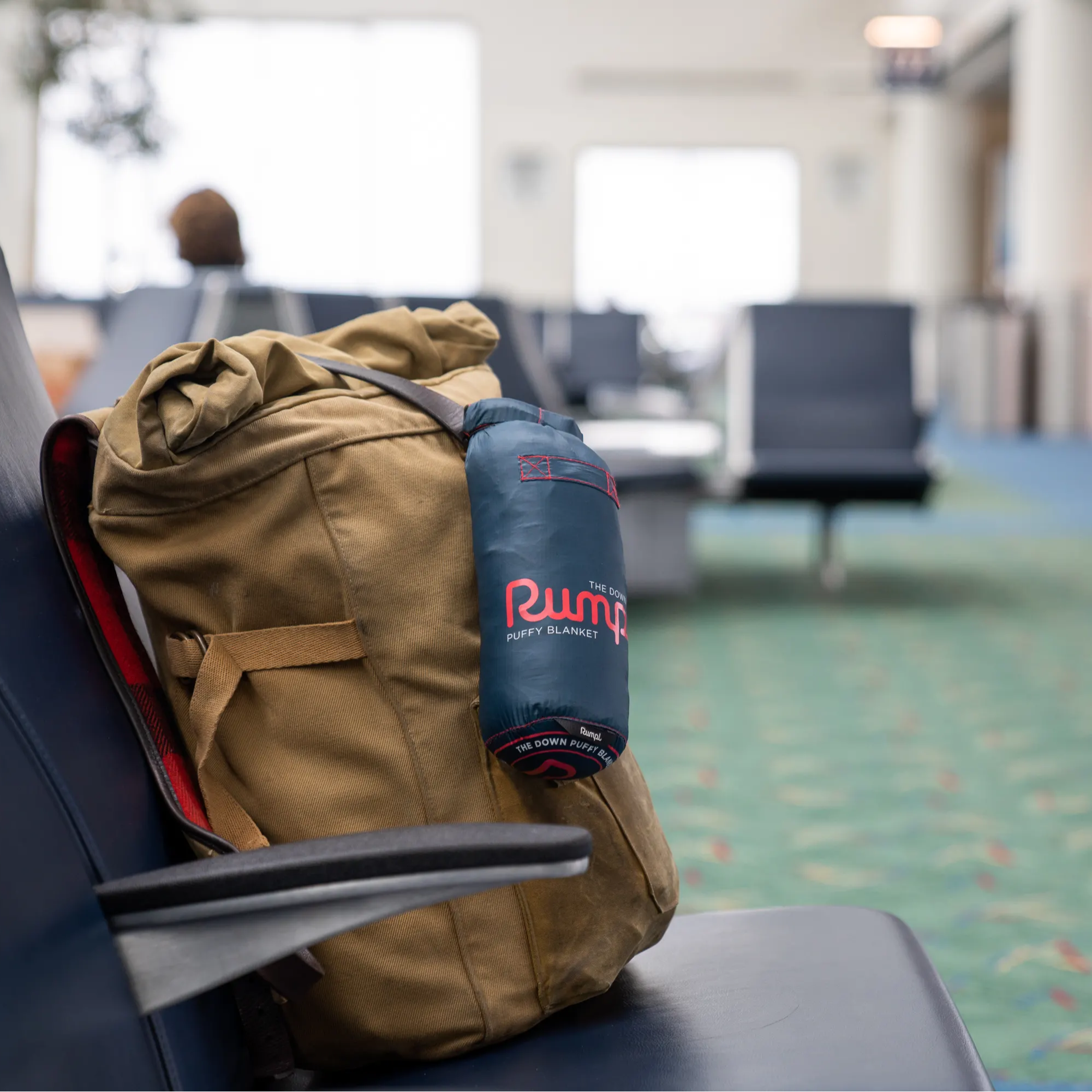 Carry on backpack in the airport with a blanket attached