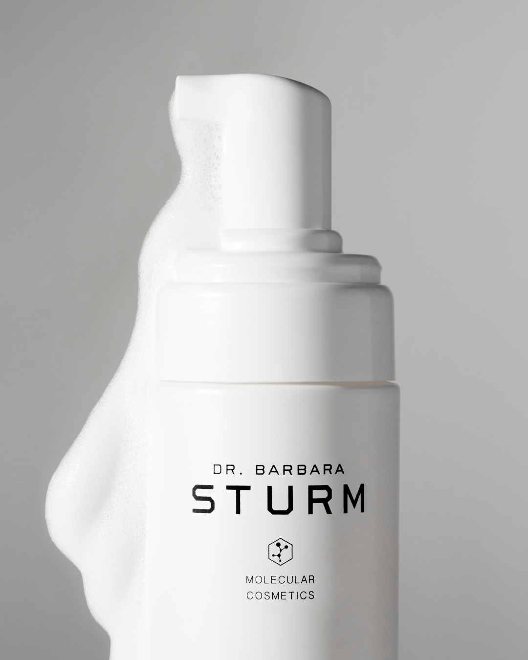Bottle of Dr. Barbara Sturm skincare product with foamy pump.
