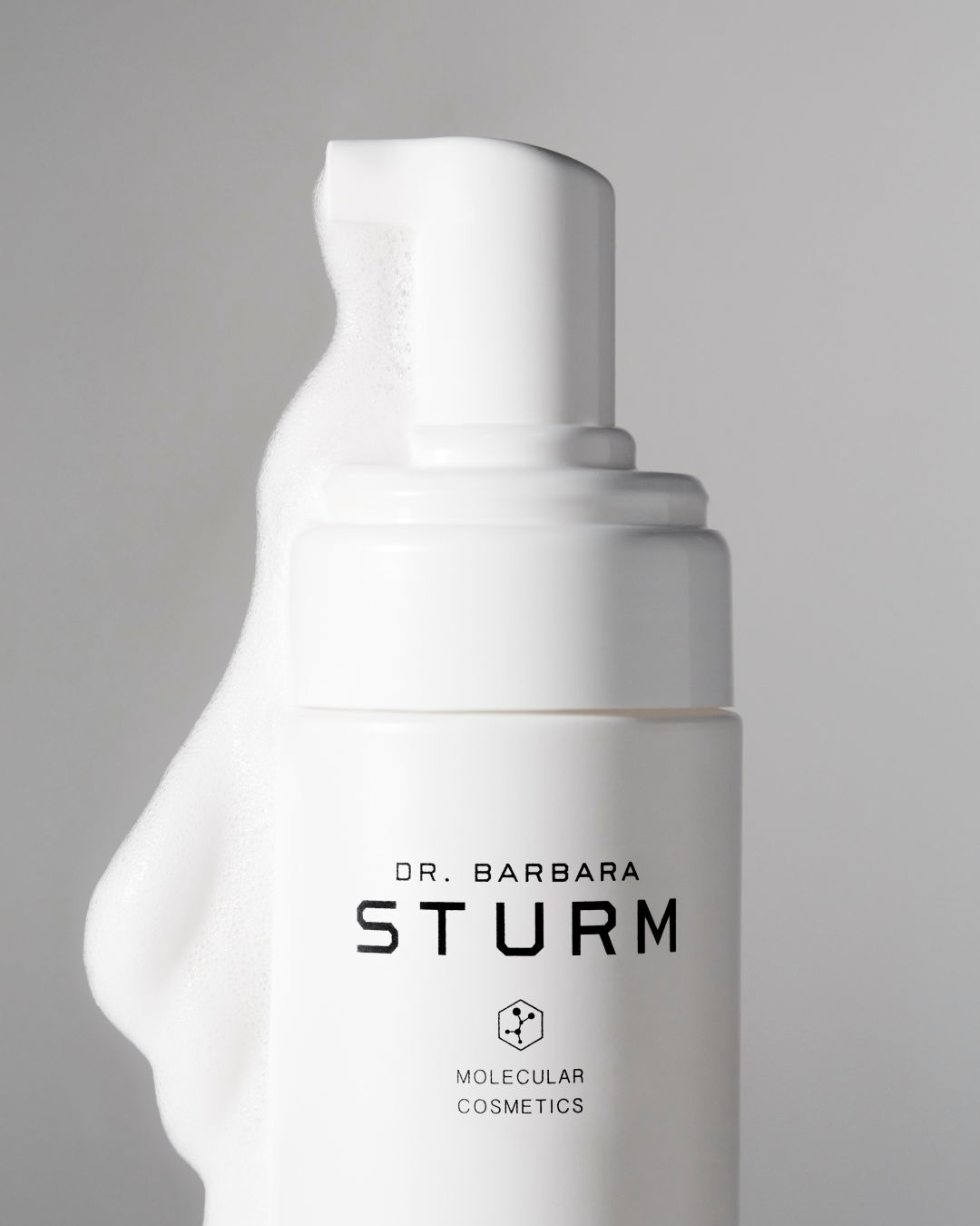 Bottle of Dr. Barbara Sturm skincare product with foamy pump.