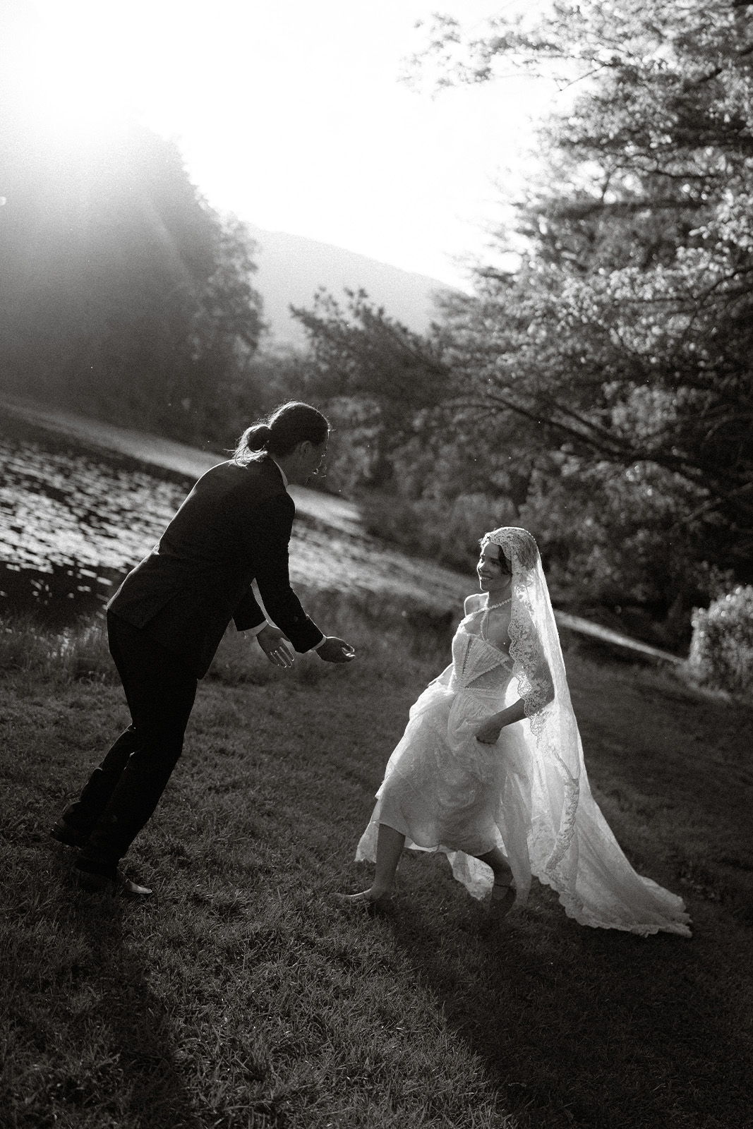 Bride and groom dancing outdoors in black and white.