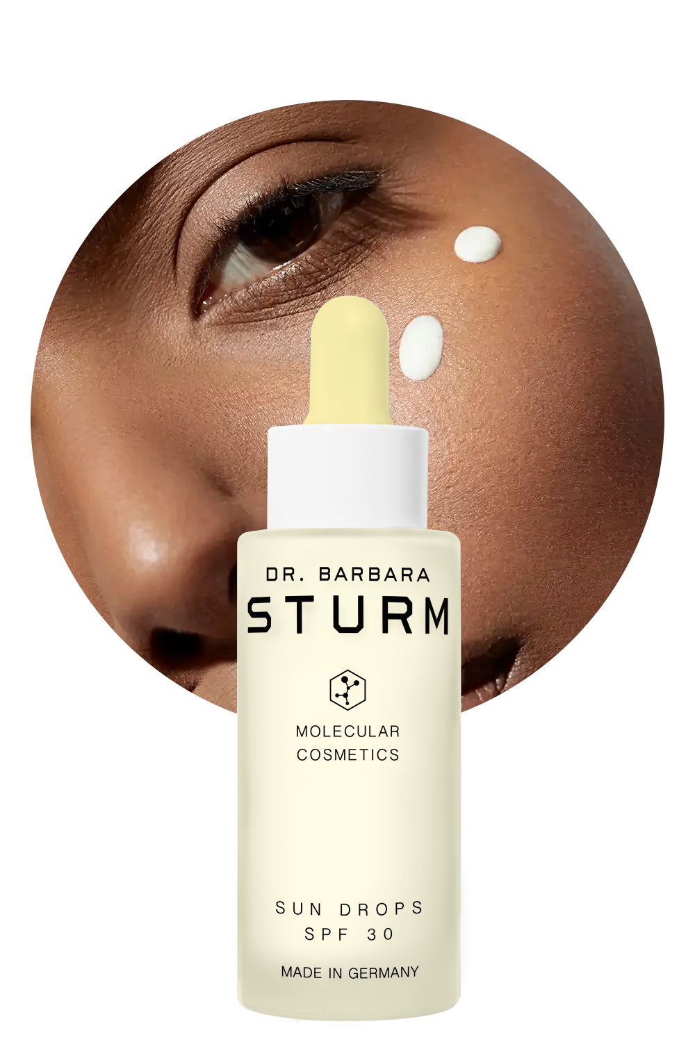 Bottle of Dr. Barbara Sturm Sun Drops SPF 30 with skin close-up.