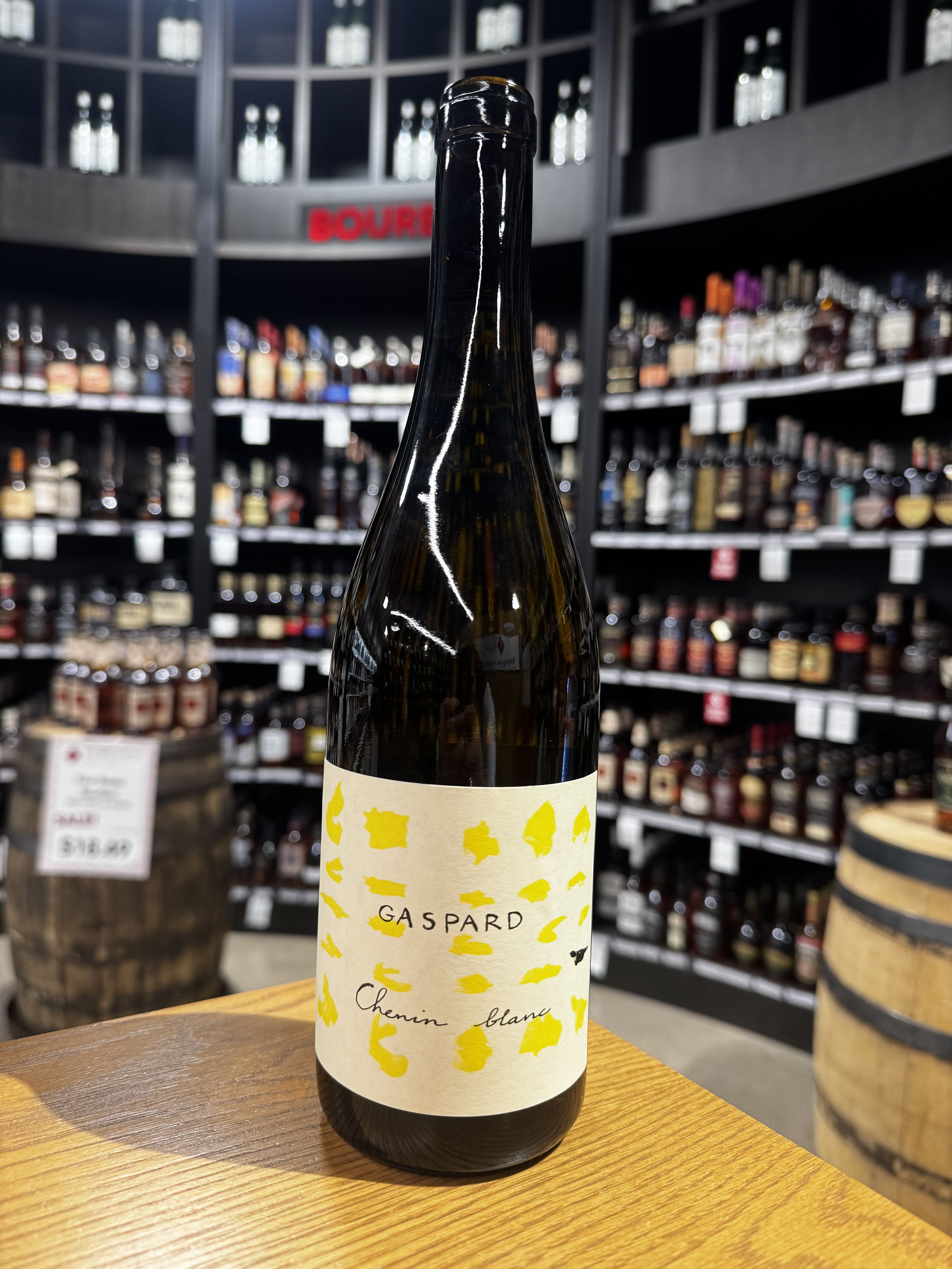 A bottle of wine with a colorful label displayed in a store.