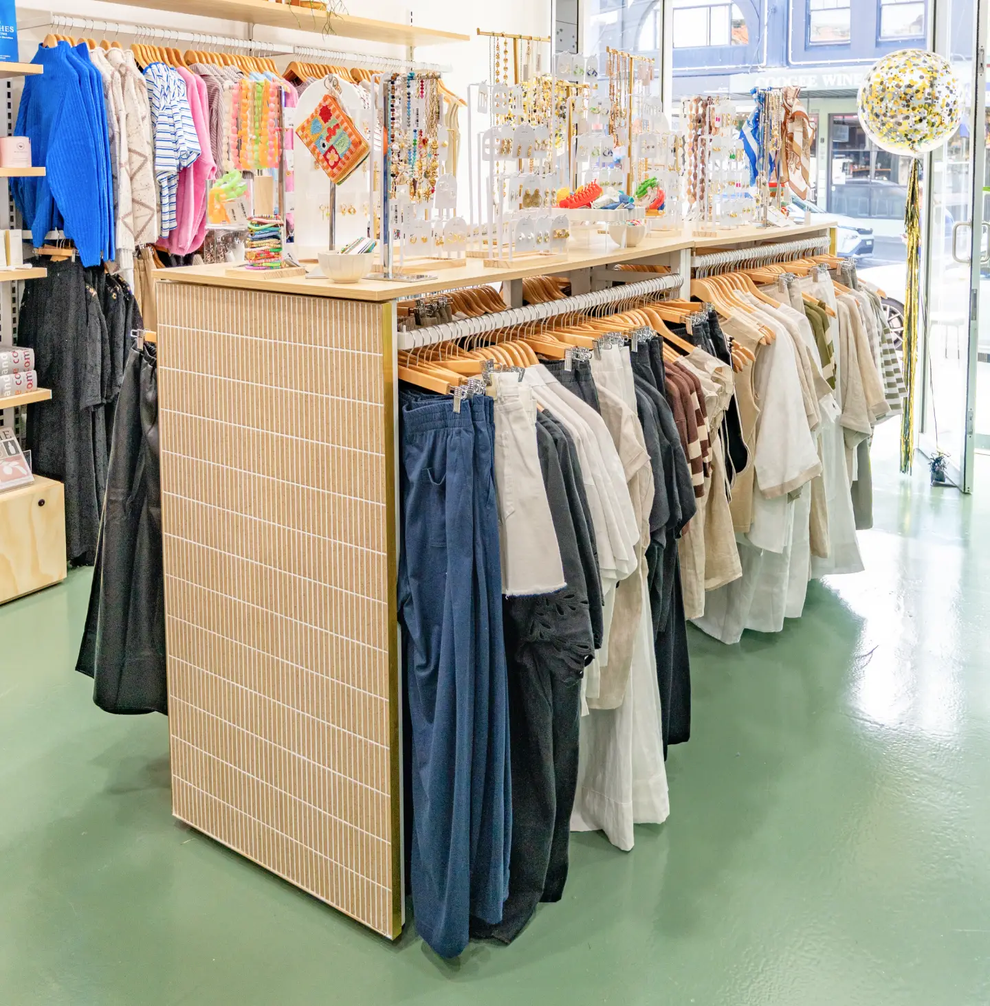Clothing rack displaying various garments in a retail store.