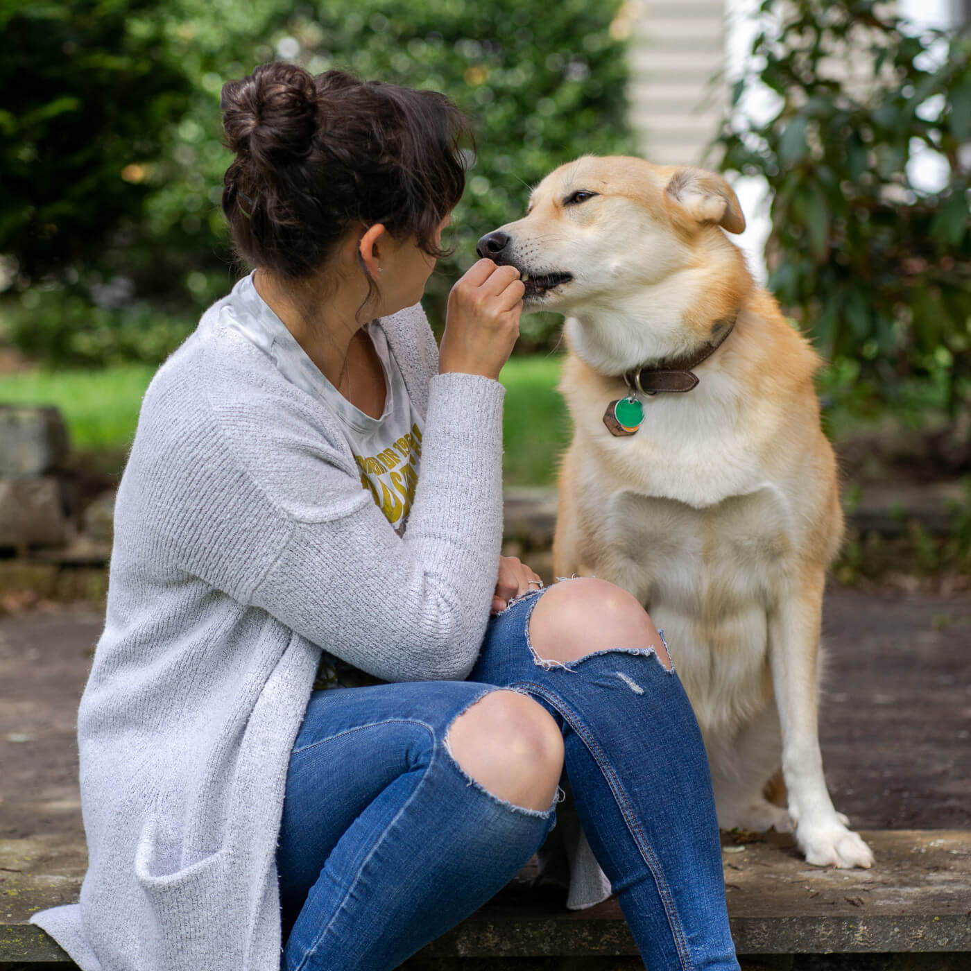 Morgan feeding her dog Lulu a treat.