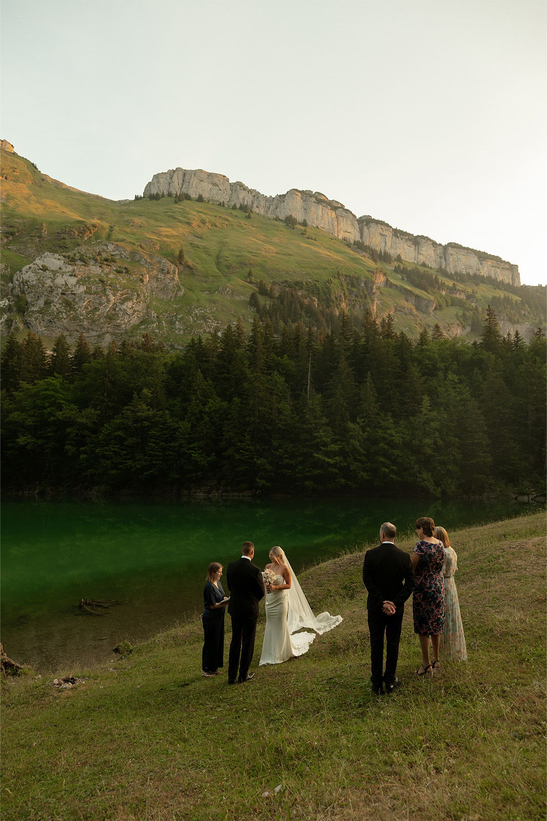 A wedding ceremony taking place in a scenic mountainous area.