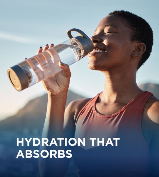 Person drinking water from a clear bottle, promoting hydration.