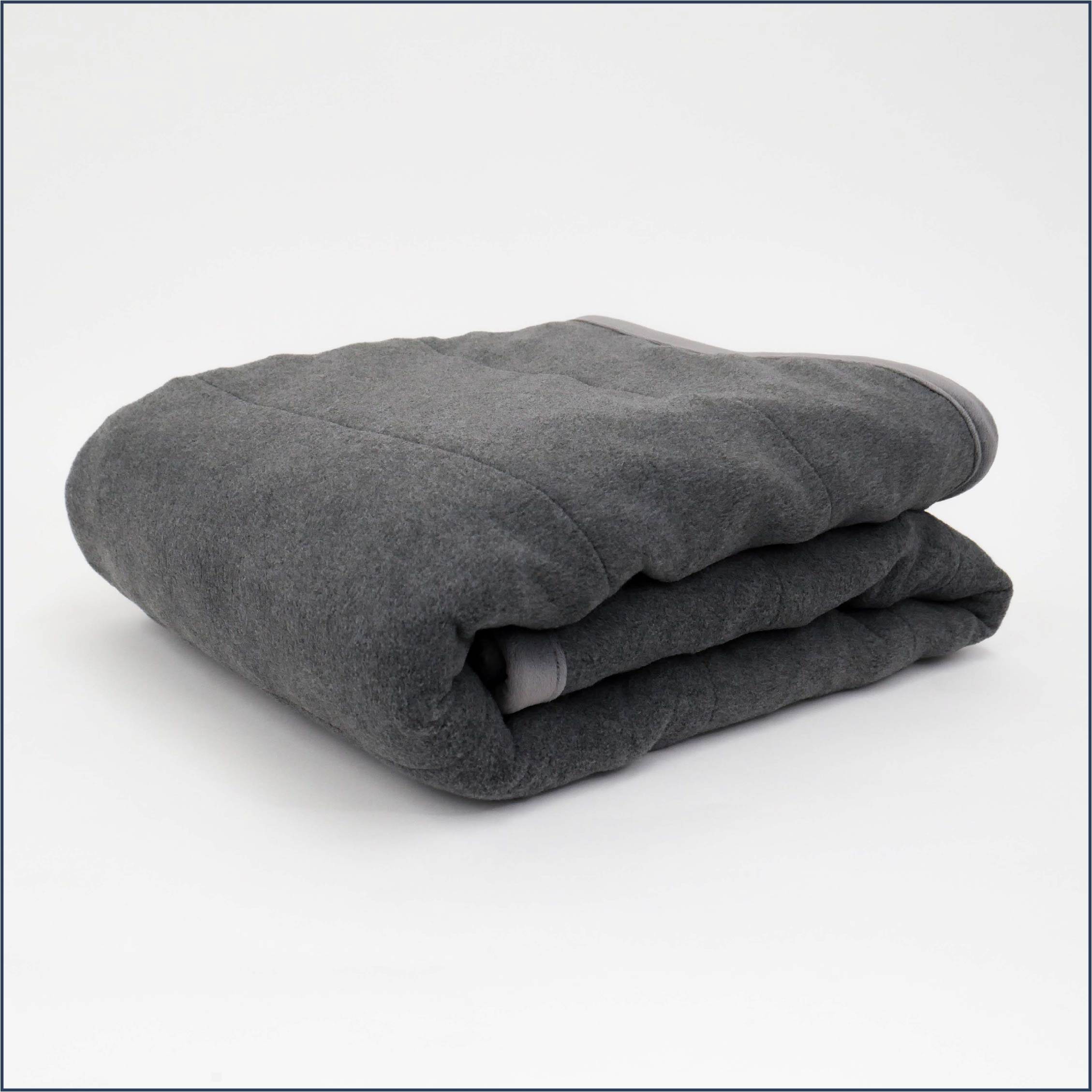The Tuc Fleece Weighted Blanket folded on a white background
