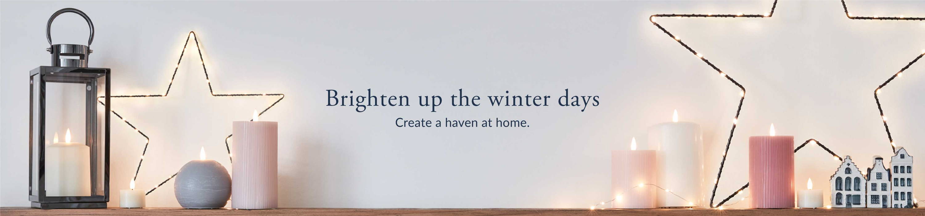 Brighten up the winter days banner with osby stars, LED candles, a black lantern and fairy lights. Text reads: create a haven at home.