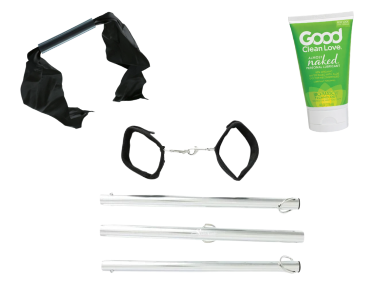 BDSM kit bundle image shows the three items that come in the kit. The image shows a portable spreader bar broken down into its travel-friendly size, a bit gag with a ribbon head fastener, and a bottle of nearly-organic sex lube.