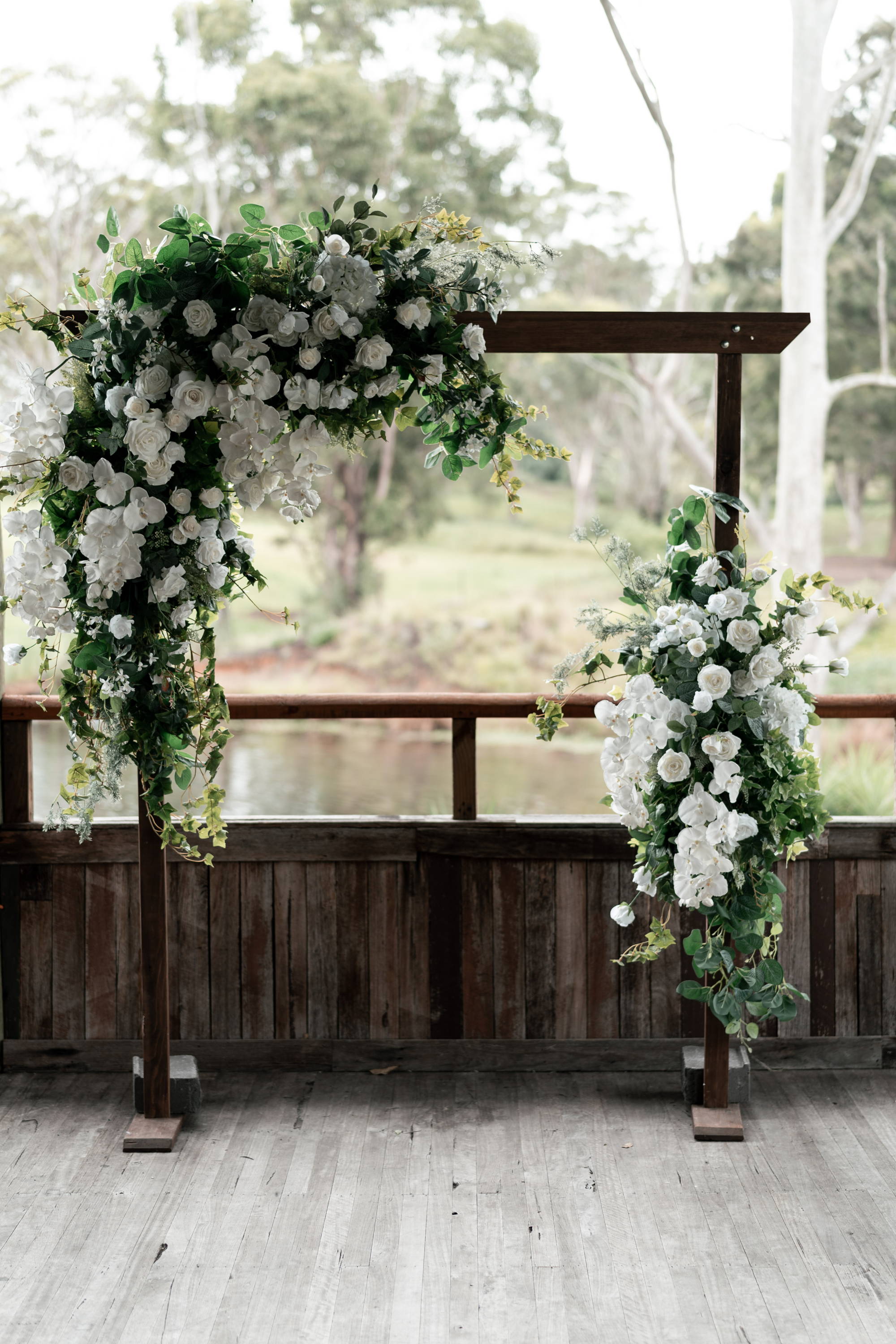 Square shaped wooden arbor with white florals