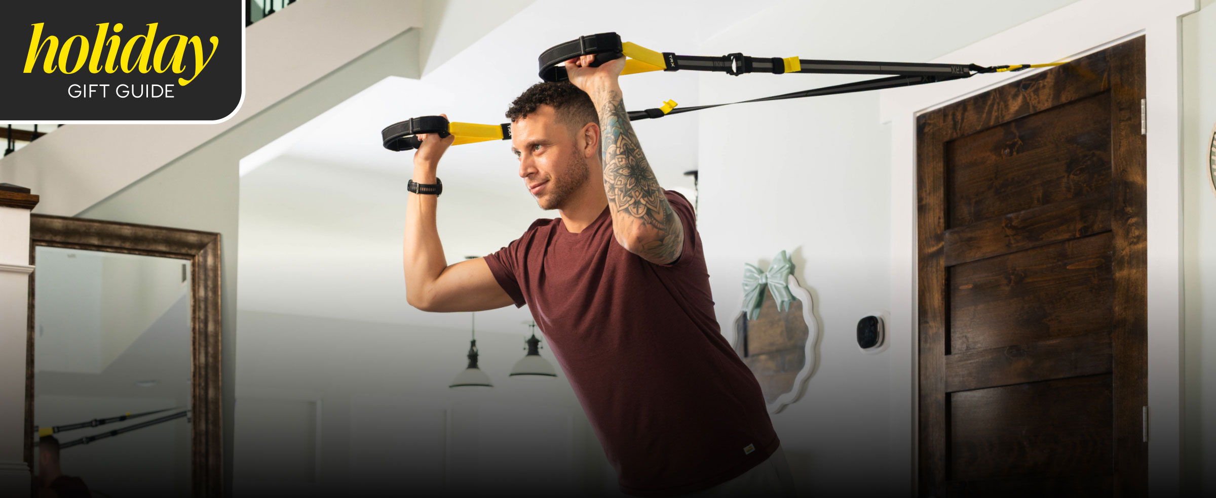 Man exercising with resistance bands in a home setting.