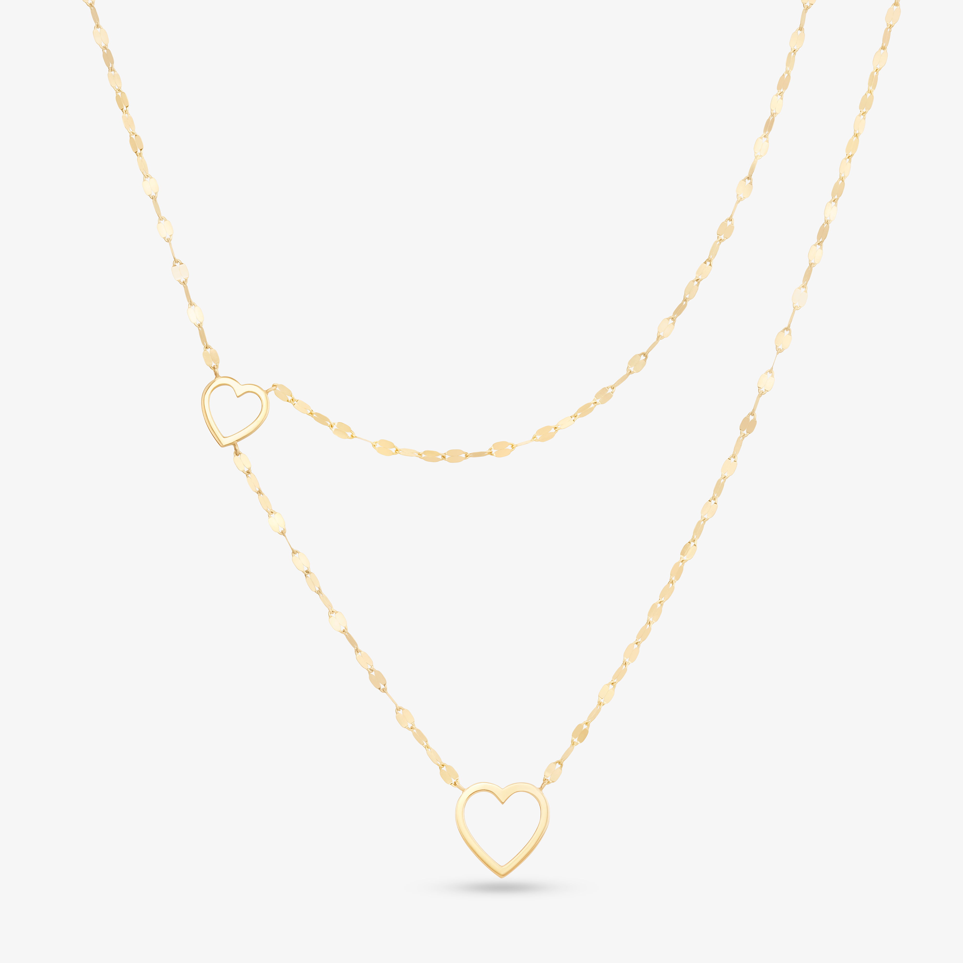Gold heart pendant necklace with two chains.