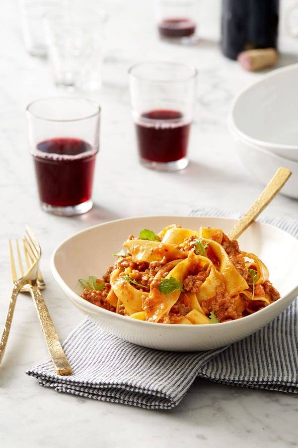 Ziti pasta in a cheesy sauce with sun dried tomatoes prepared in a pan