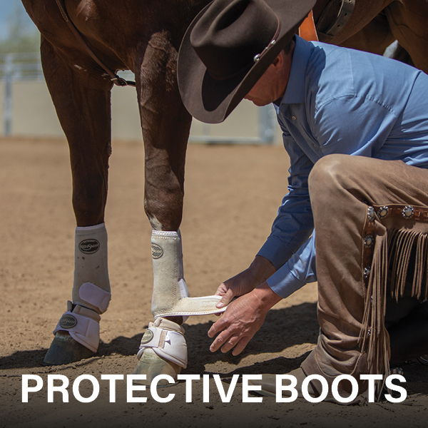 A person fitting protective boots on a horse's leg.
