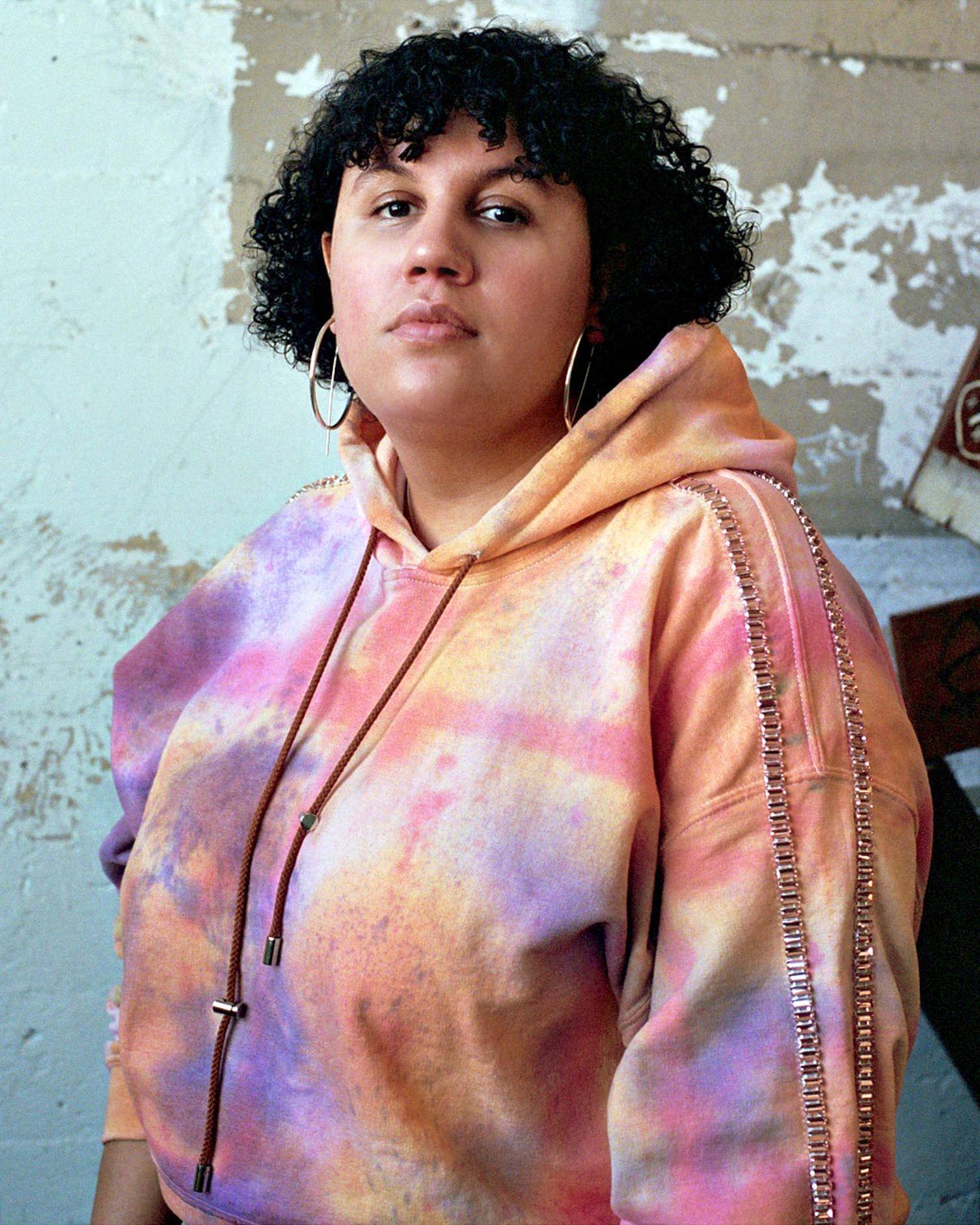 Image of Sara Ekua Todd, wearing a pink and purple tie dye hoodie from Collina Strada. 