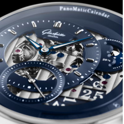 Close-up of a luxury watch face with intricate details and calendar features.