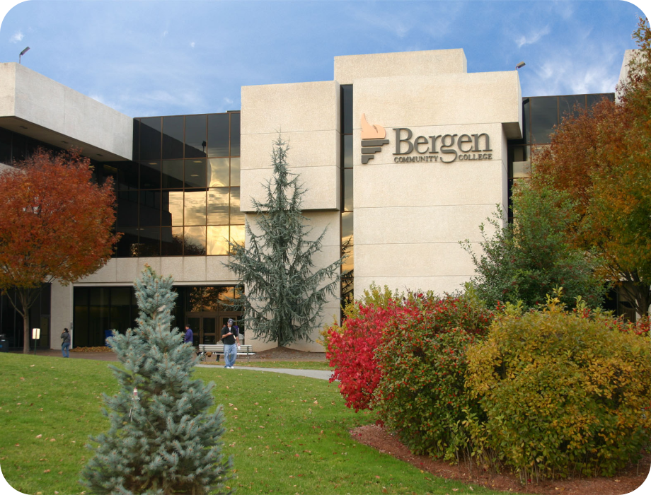 Bergen Community College building surrounded by trees and colorful foliage.