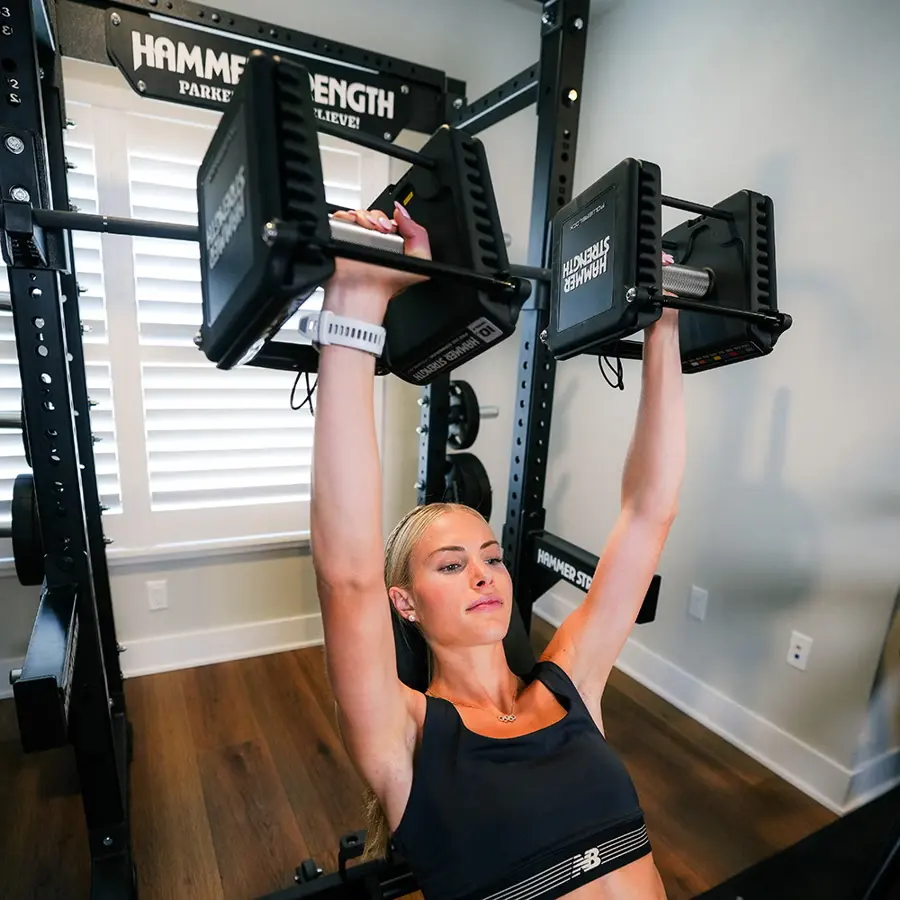 Person lifting weights in a gym setting.