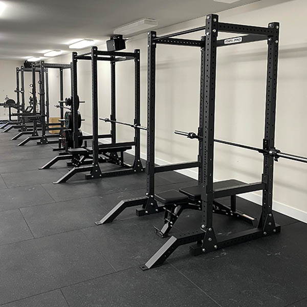 High School Gym Fit Out equipped with a professional-grade power rack, essential for advanced strength training and lifting exercises.