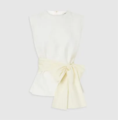 White top with a cream-colored bow tied at the waist.
