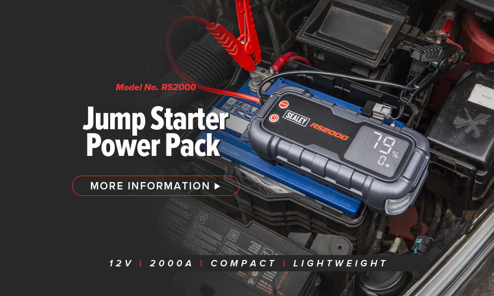 Jump starter power pack on a car battery with information text.