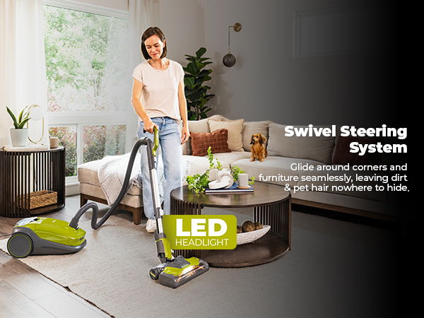 Person using a vacuum cleaner with a swivel steering system in a living room.