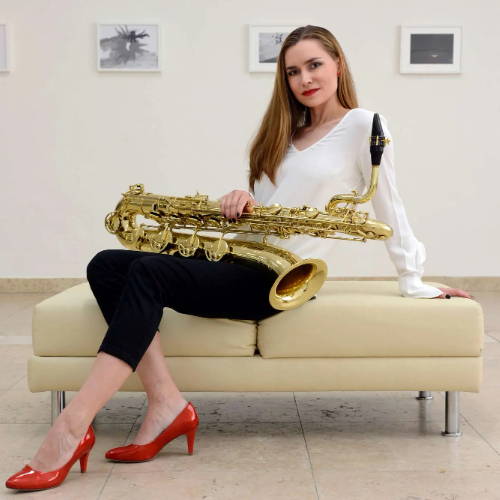Katerina Pavlikova holding a bari saxophone