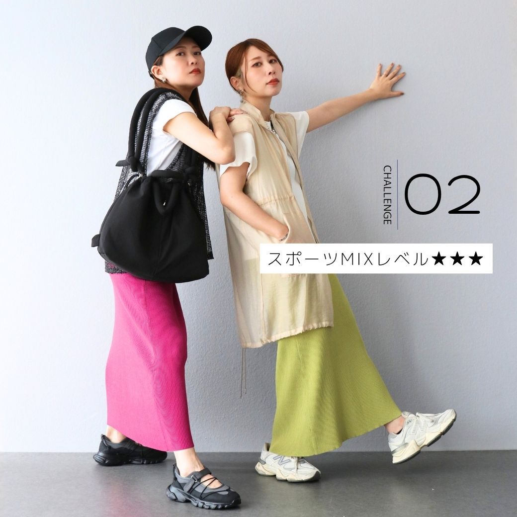 Two women in casual fashion outfits posing against a wall.