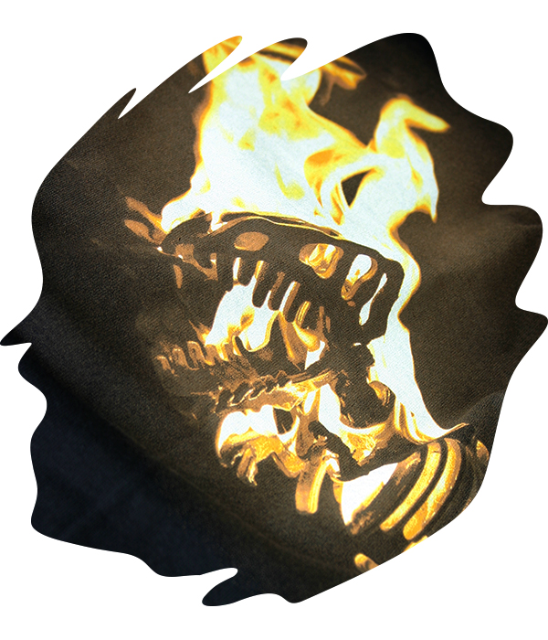 Index screen printed flaming dinosaur skull graphic on black t-shirt using limited spot colours to create high contrast yellow, orange and black tones with a distressed vintage effect