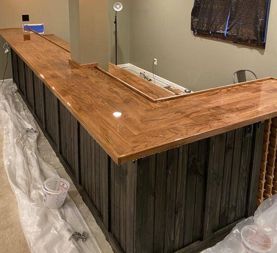 A wooden corner bar top with a coating of UltraClear Epoxy.