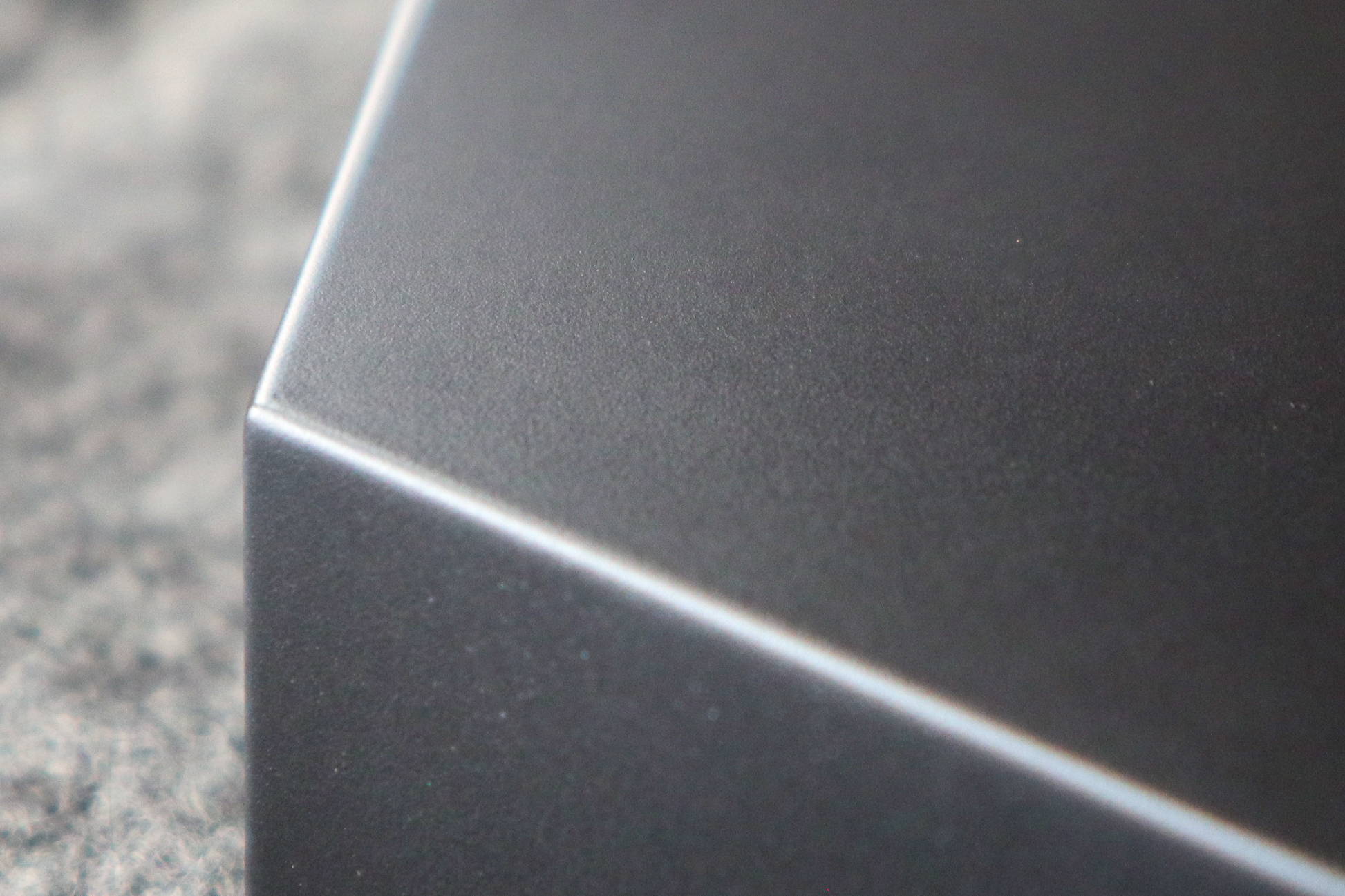 Very close up photo of the matte black base edge and side