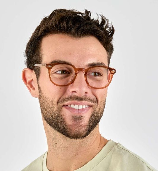 man wearing Fierce Brown browline low bridge glasses on a white background