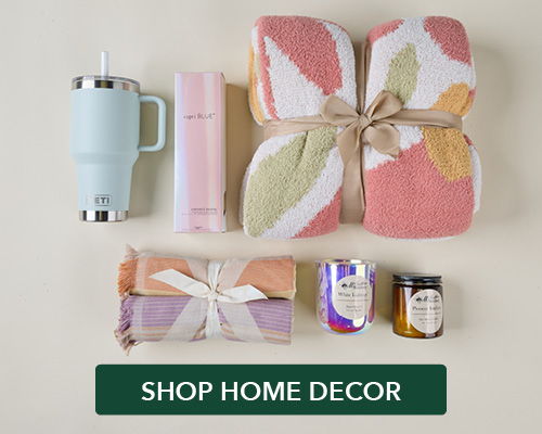 Home decor items including towels, candles, and a drink container.