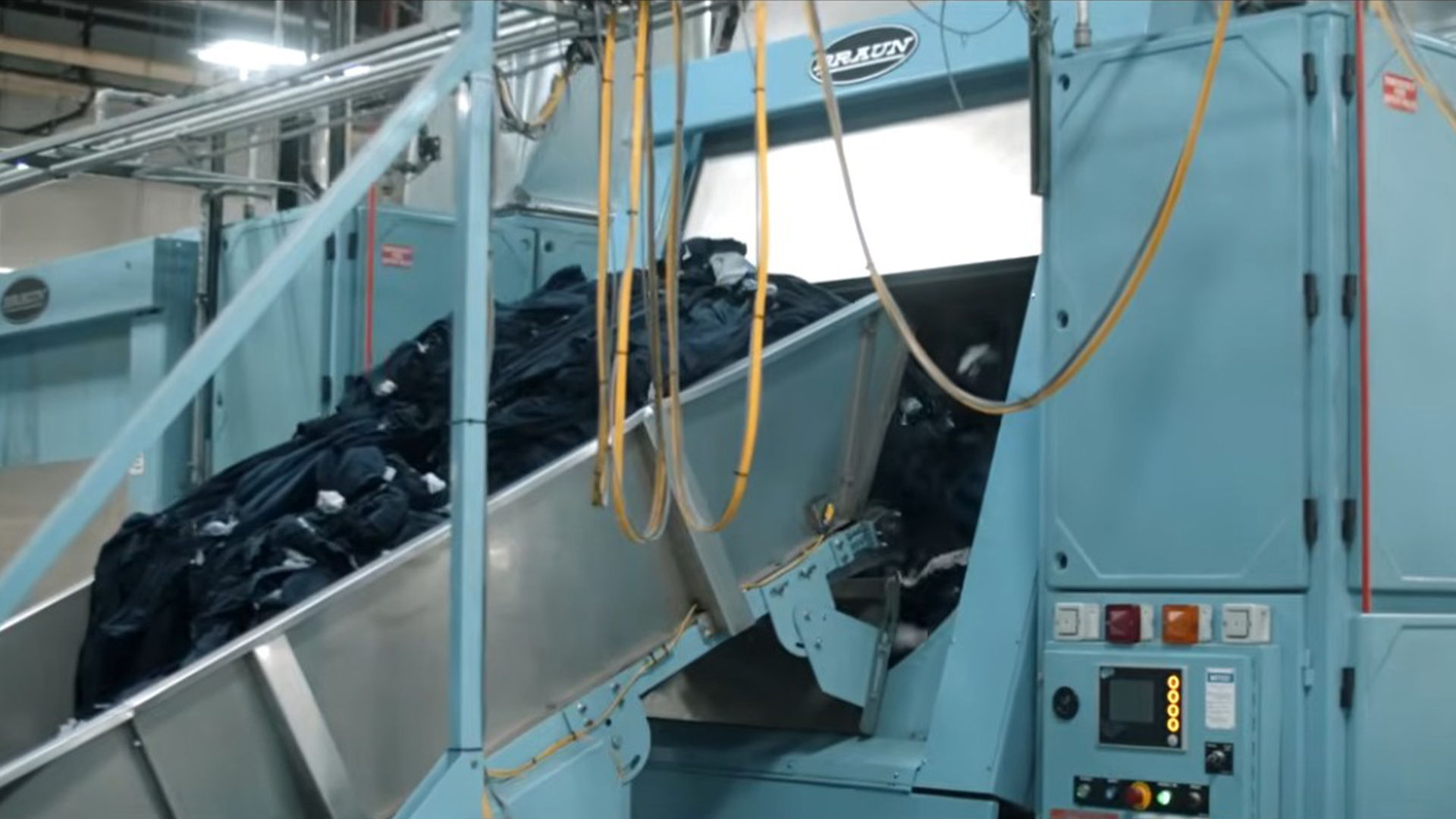 Industrial machine processing materials in a factory setting.