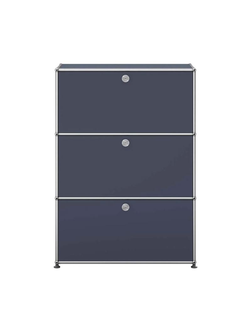 Three-drawer USM filing cabinet in dark color with circular handles.