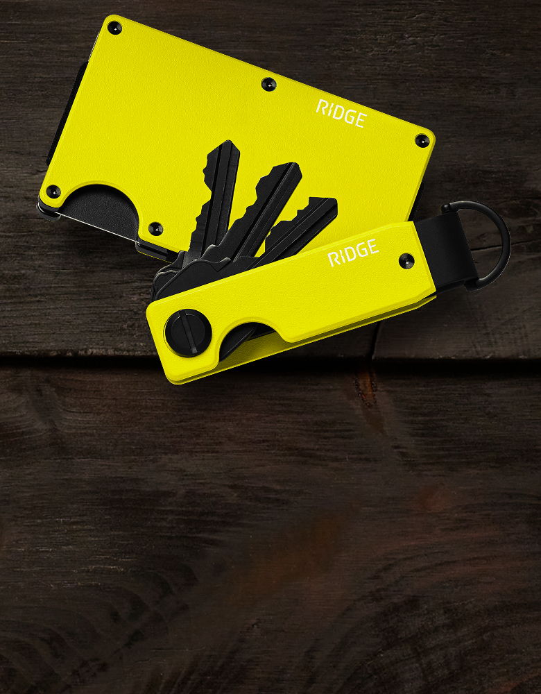Yellow key holder and wallet on a wooden surface.