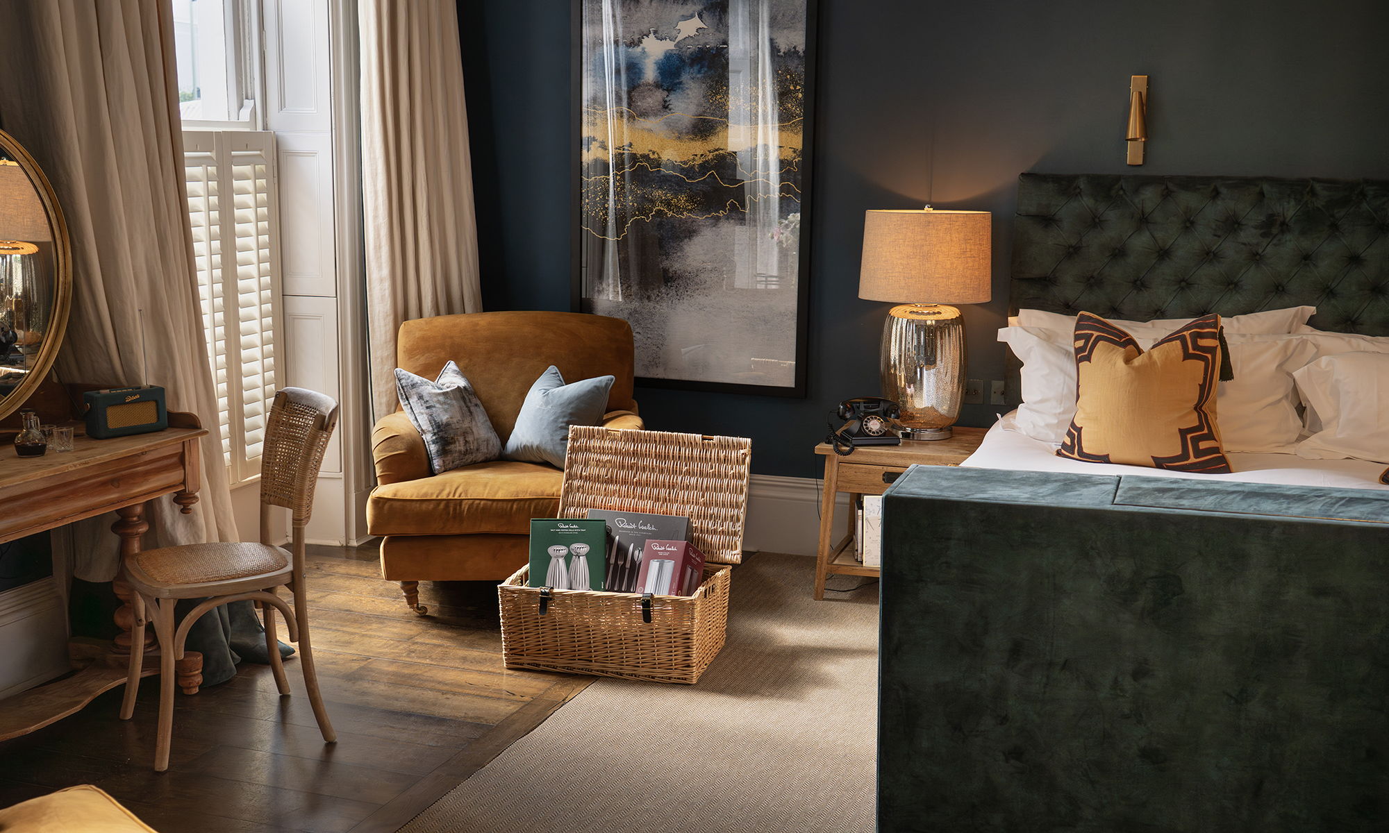 Cozy bedroom with a green bed, armchair, and decorative items.