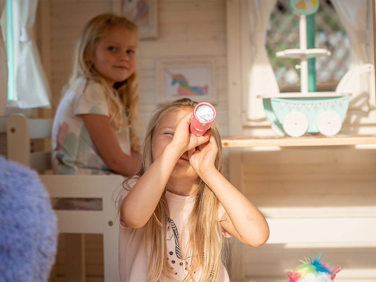 Kids playing Inside of a decorated Wooden Playhouse by WholeWoodPlayhouses