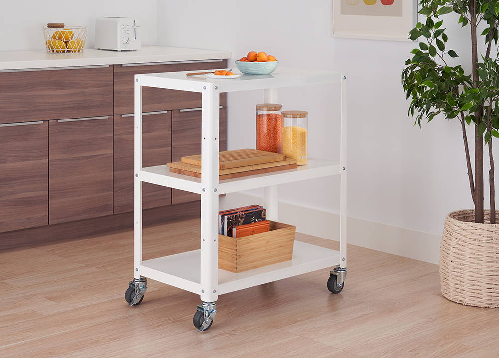 Metal utility cart in kitchen with items on shelves