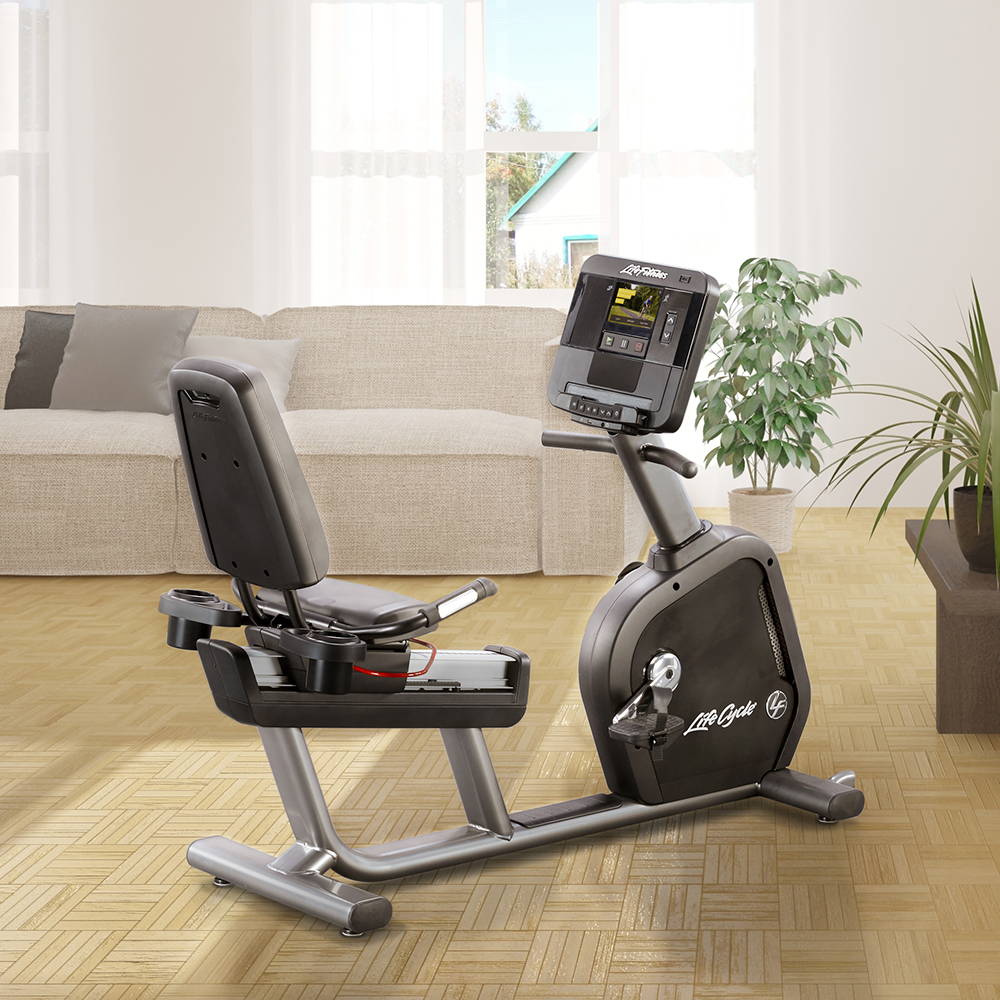 Club Series+ Recumbent exercise bike in living room of home