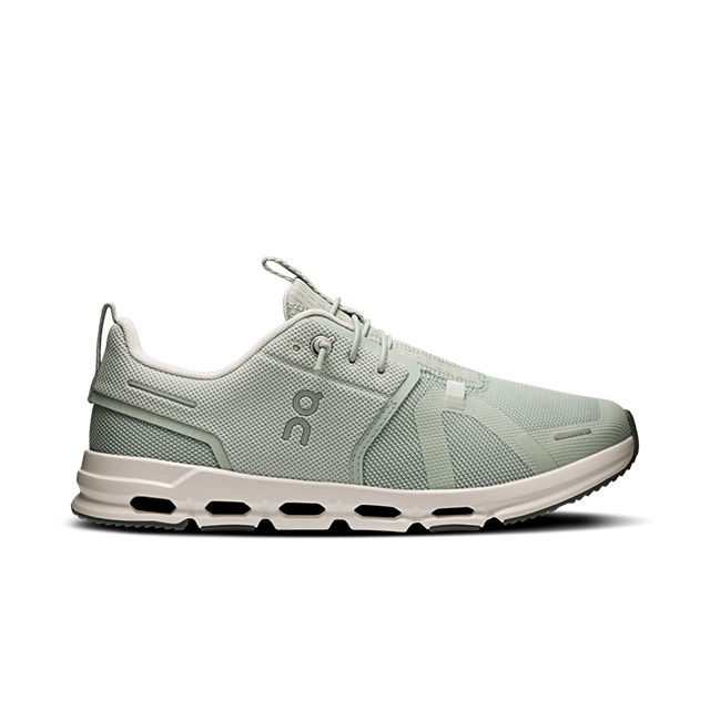 Light green athletic shoes with a white sole and logo.