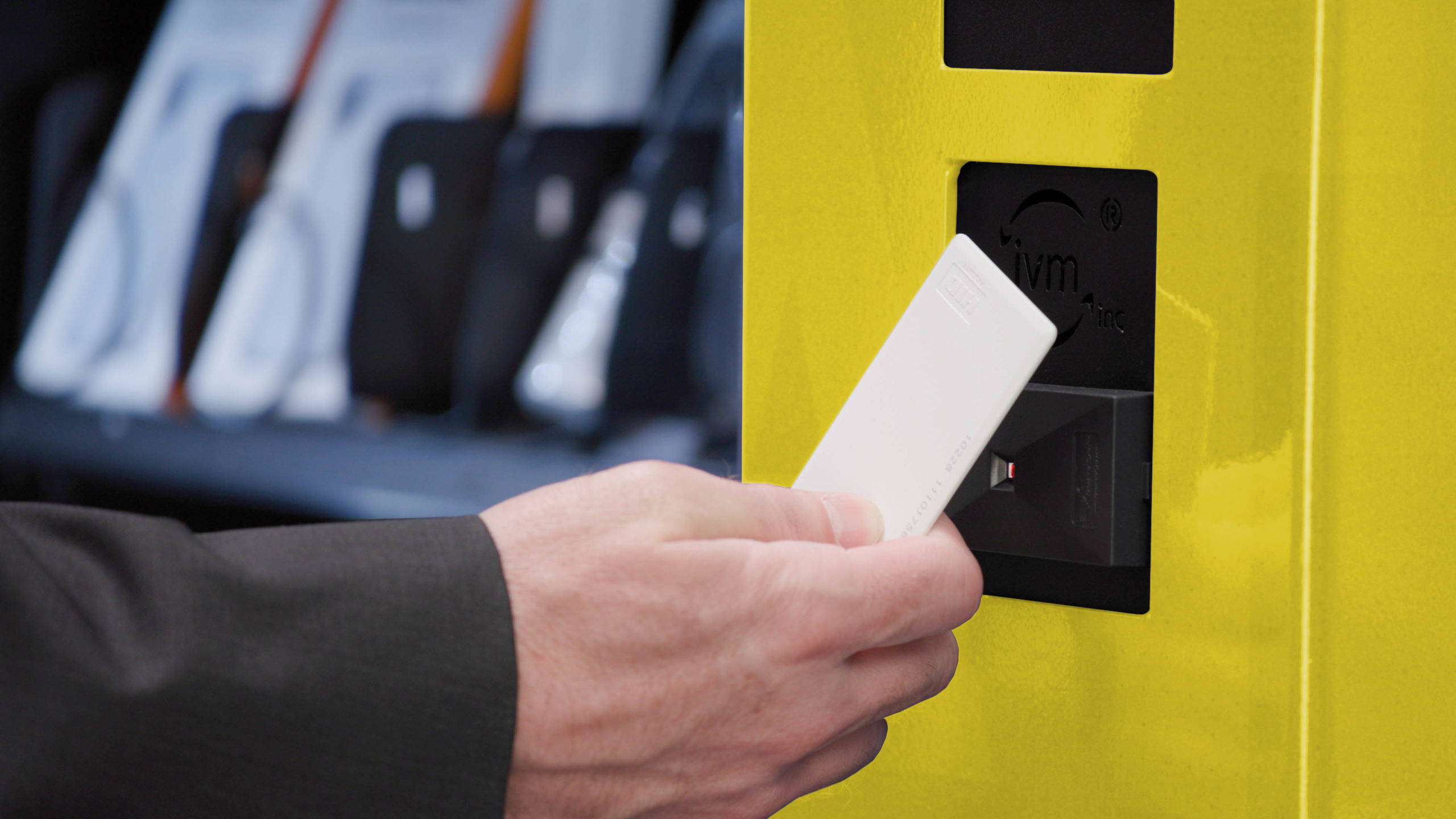 Man using card scanner on PPE Vending Machine.