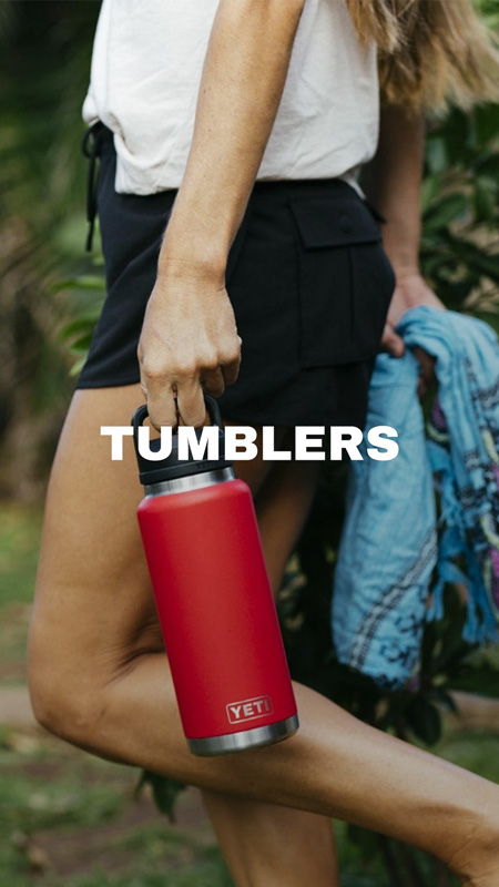 Person holding a red tumbler with 