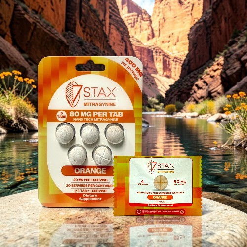 Packaging of dietary supplements by 7STAX against a scenic canyon background.