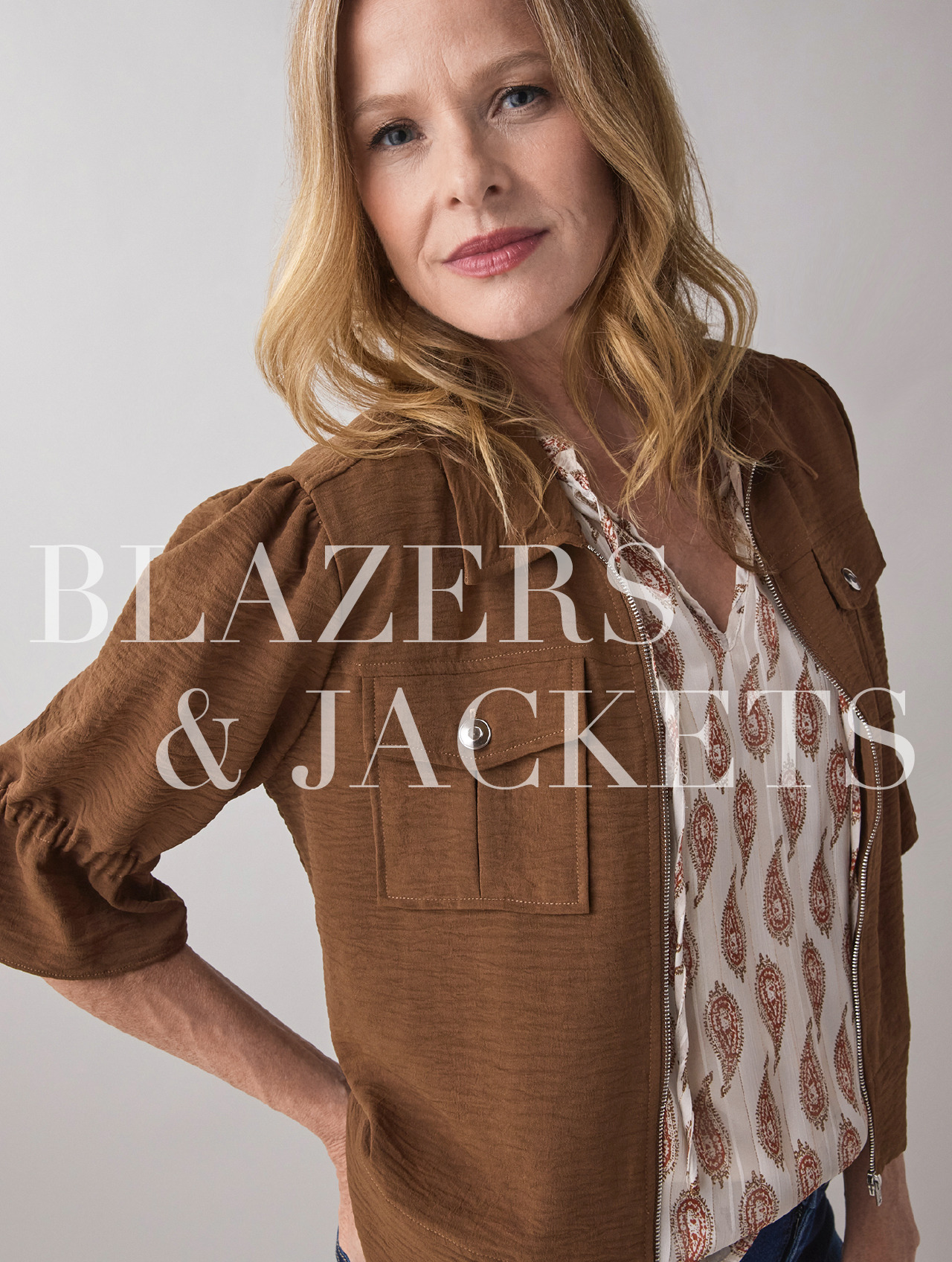 Woman wearing a brown blazer with text 